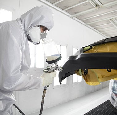 Collision Center Technician Painting a Vehicle | Sunrise Toyota North in Middle Island NY