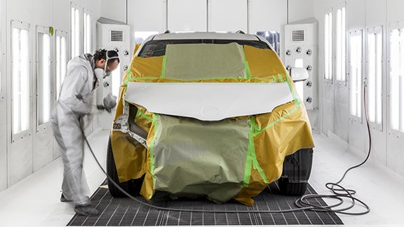 Collision Center Technician Painting a Vehicle | Sunrise Toyota North in Middle Island NY